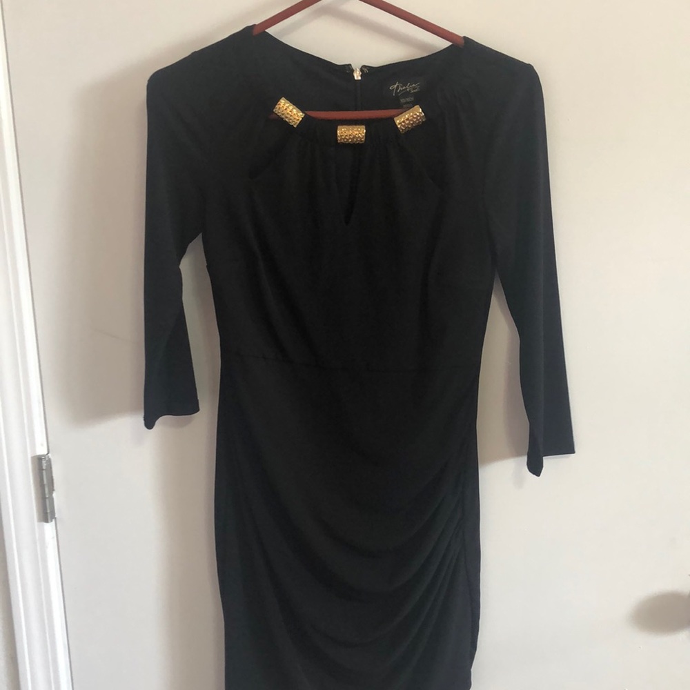 Black mini dress, with gold rings around neck